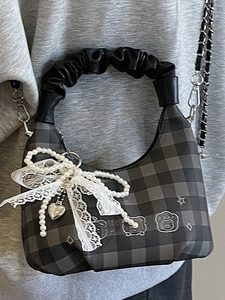 Fashionable checkered handbag with pleated handle, pearl charms, and silver chain strap
