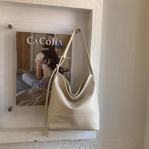 Detail view of cream white Hobo bag with adjustable knotted strap and soft PU leather