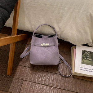 Detailed macro shot of lavender bucket bag with matte finish and silver metal twist lock