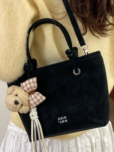 Black suede bucket bag with cute teddy bear charm and adjustable shoulder strap for women