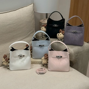 Detailed close-up of mini bucket bags in multiple colors with teddy bear charms