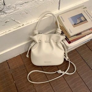 White pleated bucket bag with Pantor & Stories logo and adjustable drawstring detail