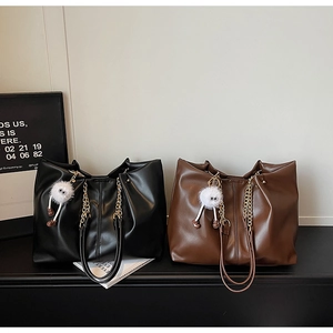 Detail showing vintage PU leather tote bags in black and brown with chain straps