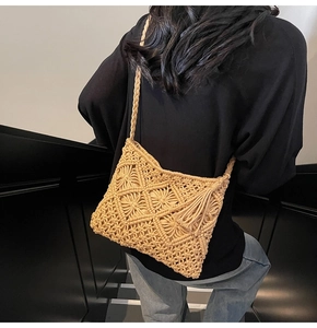 Detailed view of handmade woven cotton bag with diamond patterns and side tassels