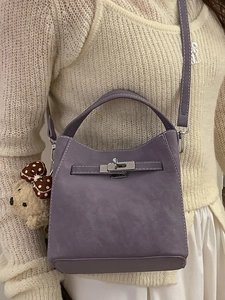 Purple lychee leather bucket bag with silver twist lock and cute plush bear accessory