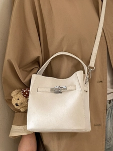 Beige bucket bag with silver rotating lock and cute brown polka dot bear charm