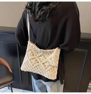 Close-up of handmade woven crossbody bag with cotton rope tassels and hollow pattern