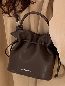 Fashionable dark brown leather drawstring bucket bag with pleated texture and top handle