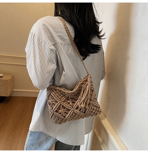 Detail of handmade beige macramé shoulder bag with fringe tassels and floral weaving