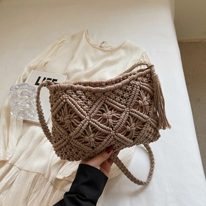Detail of bohemian handmade woven bag with fringe tassels and rhombus mesh pattern