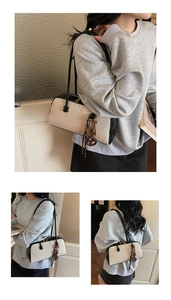 Detailed views of the contrast beige canvas and black leather shoulder bag in use