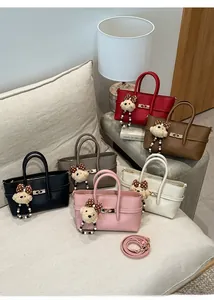 Detailed view of six colors of lychee grain leather handbags with cute bear pendants