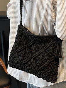 Handmade black macrame shoulder bag with geometric patterns and fringe tassel decoration