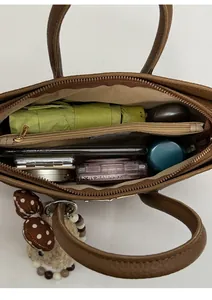 Top view of brown leather handbag interior showing large capacity and zipper pocket
