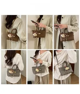 Detail shots of textured leather handbag with mini bear charm and adjustable strap