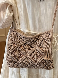 Handmade beige macrame crossbody bag with woven diamond patterns and long fringe tassels