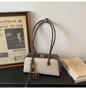 Detail view of large capacity vintage canvas patchwork shoulder bag with elegant charms
