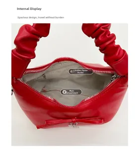 Top view of red faux leather bucket bag showing main compartment and zippered inner pocket