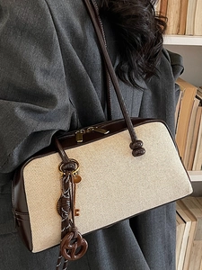 Retro beige and brown Boston shoulder bag styled with a professional grey blazer outfit