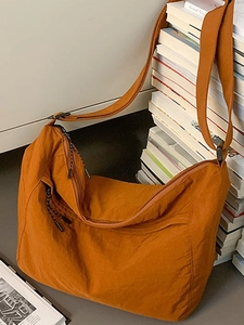 Minimalist caramel crescent shoulder bag in nylon with large capacity and adjustable strap