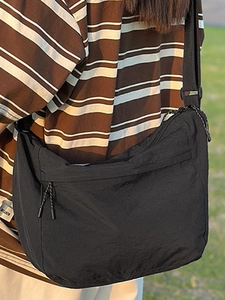 Minimalist black large capacity nylon messenger bag with adjustable strap for daily use