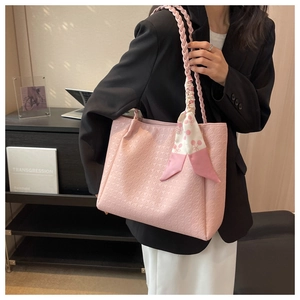 Detailed pink houndstooth tote bag featuring woven handles and a cherry pattern silk scarf
