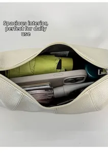 Spacious interior of off-white lychee leather bag with folding umbrella and phone