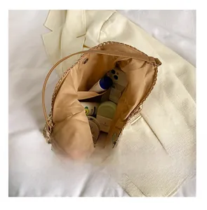 Internal view of a large woven tote bag showing spacious capacity with makeup items