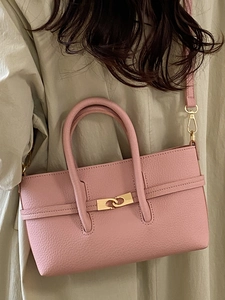 Pink lychee texture leather handbag with gold twist lock and adjustable shoulder strap