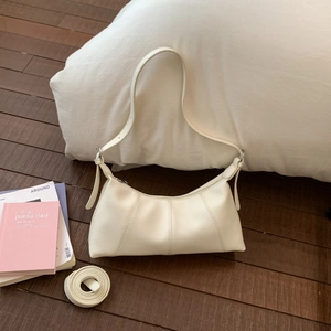 Detail of white lychee leather hobo bag with pleated stitching and dual straps