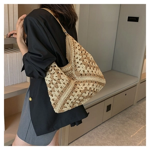 Close-up of beige crochet shoulder bag showing detailed hollow weave and textured fabric