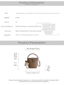 Brown lychee grain bucket bag with a cute bear charm and metal twist lock detail