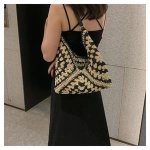 Detailed close-up of a large bohemian woven tote bag worn on a shoulder