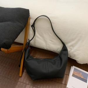 Close-up of black crescent hobo bag in lychee pattern leather with wide shoulder strap