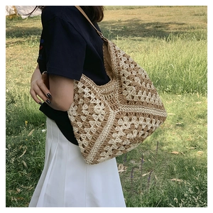 Detail of hand-woven hollow knit tote bag with beige contrast patterns and leather strap