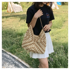 Close-up of geometric woven pattern on summer crochet tote bag with brown straps