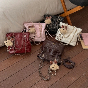 Quilted leather chain tote bags with bear charm in burgundy, pink, black, and white