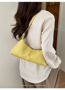 Minimalist bright yellow lychee leather dumpling bag with retro patchwork design