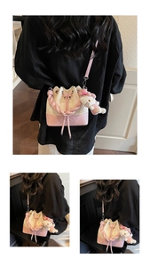 Detail of a pink and white bucket bag with star embroidery and cute plush charm
