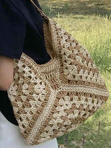 Large woven hobo tote bag with patchwork crochet pattern and brown leather strap
