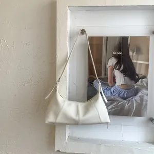 Detailed view of the off-white hobo bag showing the high-quality lychee texture leather