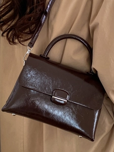 Minimalist dark brown patent leather square handbag with top handle and shoulder strap