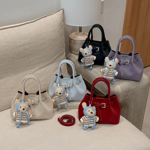 Detailed display of vintage bucket bags in five colors with cute bear charm on sofa