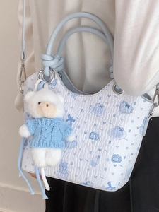 Blue and white printed water bucket crossbody bag with a cute plush bear pendant accessory