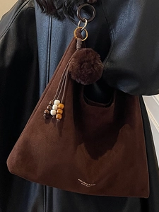Brown suede tote bag for women with plush ball charm and beaded tassel detail