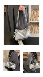 Detail view of silver pillow tote bag showing zipper closure and metallic PU texture
