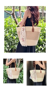 Detail of beige woven straw tote bag with brown gradient stripes and floral lace ribbon
