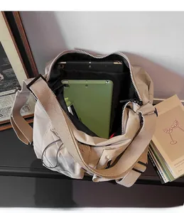 Interior detail of large nylon messenger bag showing spacious capacity for tablets