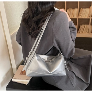 Detailed back view of a metallic silver underarm bag with soft leather texture and straps