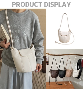 Detailed view of women's litchi grain bucket bags in cream, black, and khaki finishes